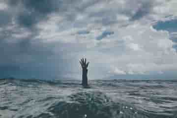 A drowning person raising hand representing H & C situation