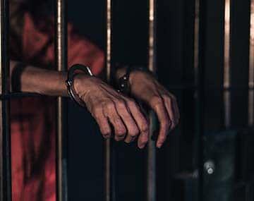 A past picture behind bars representing criminal rehabilitation 
