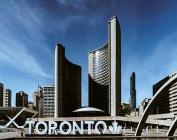 Permanent resident card (PR) card renewal background has Toronto buildings